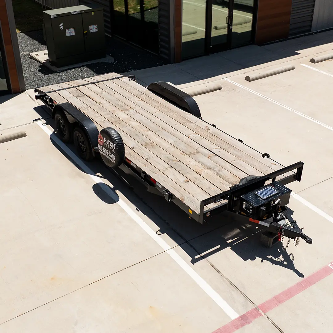C&M 20-foot car and truck hauler with treated wood deck, parked and ready to rent in Krugerville, North Texas